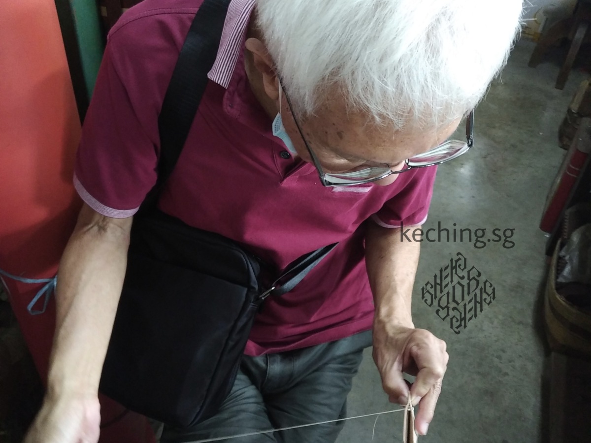 My elderly retiree uncle working a cardholder craft kit